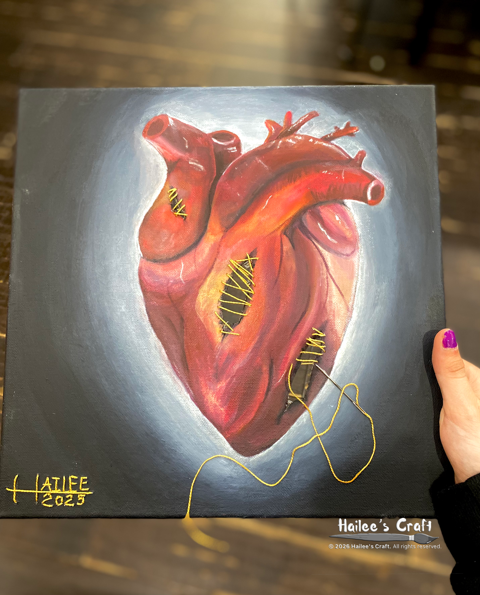 an atomically correct heart painted on a square canvas. the painting has several holes in it. the holes are sewn up with gold thread but, the holes are still visable.